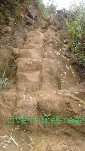 A vertical rock cliff marking half way