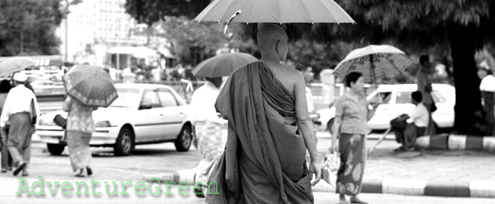 A Buddhist monk on a street at Yangon, Myanmar" title="A Buddhist monk on a street at Yangon, Myanmar