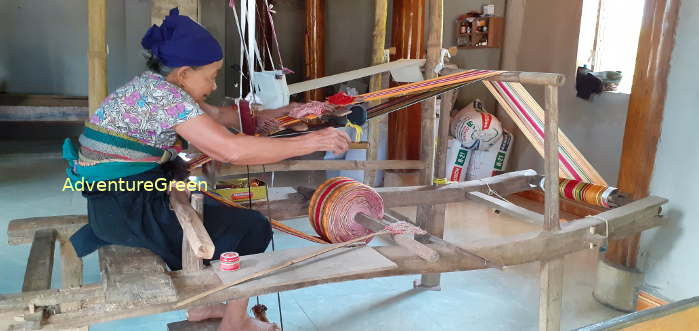 An old Thai lady at work on the weaving loom at Nam Ngoai Village
