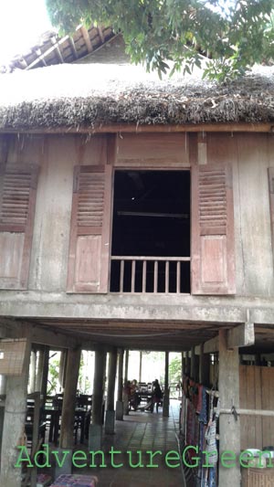 A house on stilts with a shop underneath