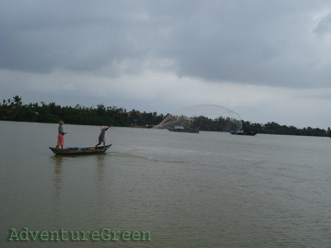 A couple fishing on the Thu Bon River at Hoi An