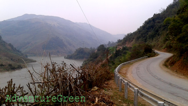 A scenic road by the Da River and lovely mountains around at Bac Yen, Son La Province