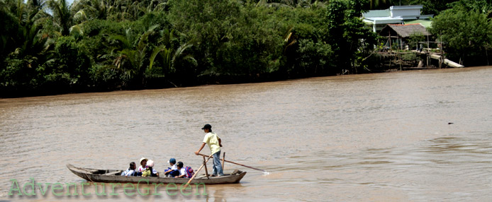 A rowing boat carrying kids to school at Tra Vinh