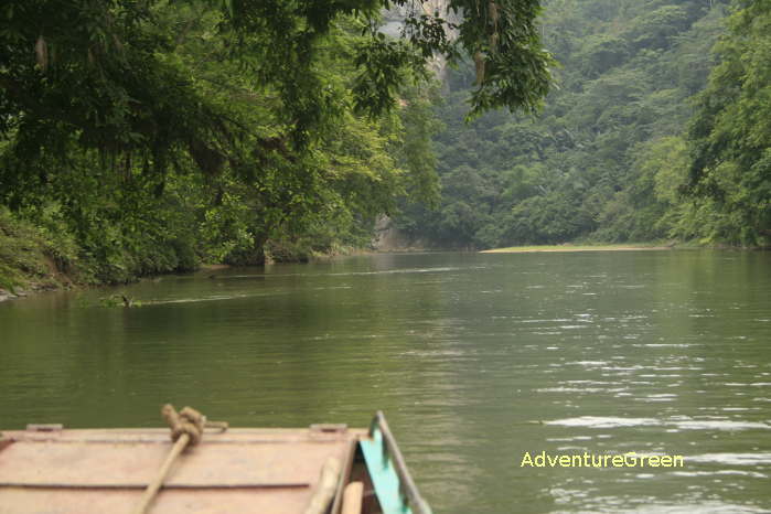 Boat trip on the Ba Be Lake amid towering forested mountains