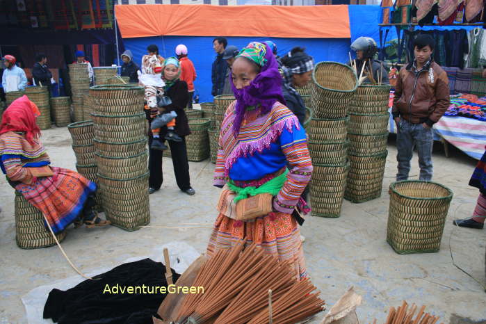 A Hmong lady with jossticks for sales at the Bac Ha Sunday Market