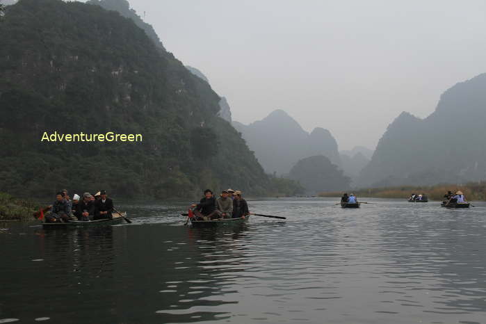 Rowing boats at Trang An Scenic Landscape in Ninh Binh Province, Vietnam